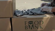 Woman Folding Masks At La Food Bank During Covid-19 Coronavirus Pandemic Stock Footage