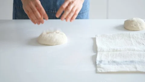 Woman forms balls for bread from raw dough with her own hands. Bread 4K Stock Footage 121527421