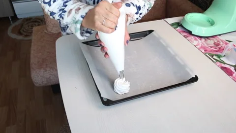 A woman forms the base for a cake with a pastry bag. Cooking cake Anna Pavlov Stock Footage 210778063