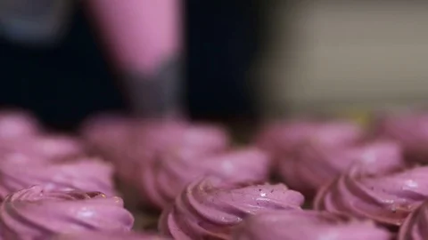 Woman forms marshmallow with help portion bag in kitchen indoors. Stock Footage 79348592