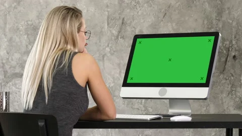 Woman freelancer looking at computer monitor. Green Screen Mock-up Display. Stock Footage