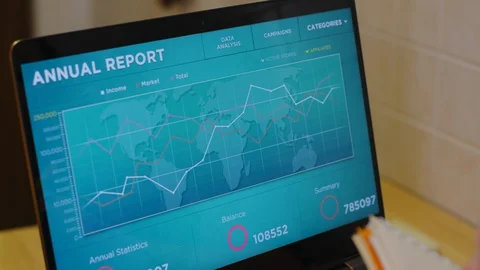 Woman freelancer taking notes while checking graphs Stock Footage 130131210