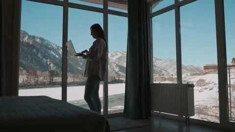 Woman freelancer working using laptop while standing by the window. Stock Footage 170116668