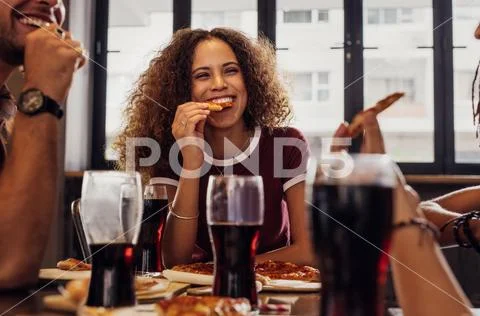 Woman with friends enjoying a meal Stock Photos