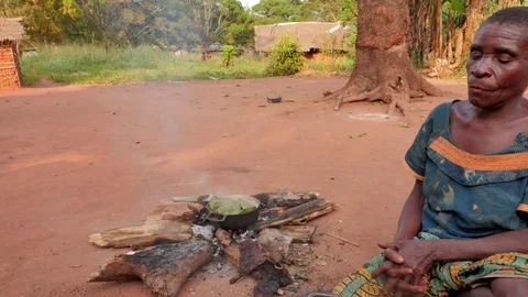 Woman in front of the fire while cooking Stock Footage 107309677
