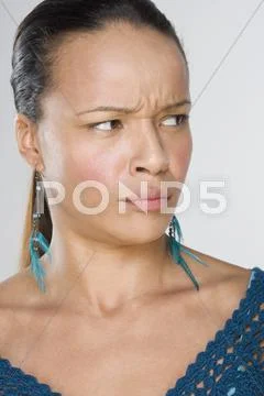 Woman frowning while looking off to side Stock Photos