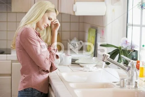 Woman frustrated at kitchen counter Stock Photos