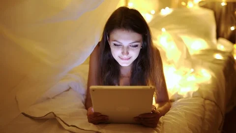 Woman gaming tablet computer touchscreen touchpad at night dolly shot with Stock Footage 72395338