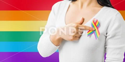 Woman with gay pride awareness ribbon on her chest Stock Photos