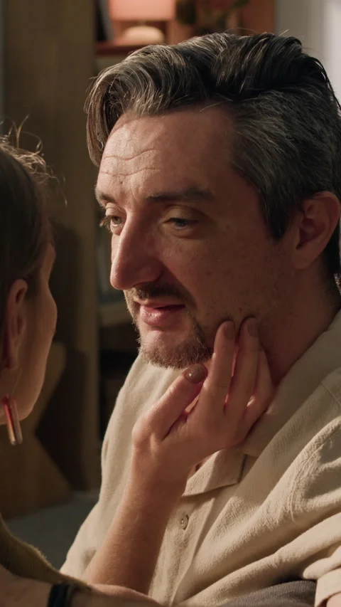 Woman Gently Touching Face of Middle Aged Man during Romantic Moment Stock Footage 338088060