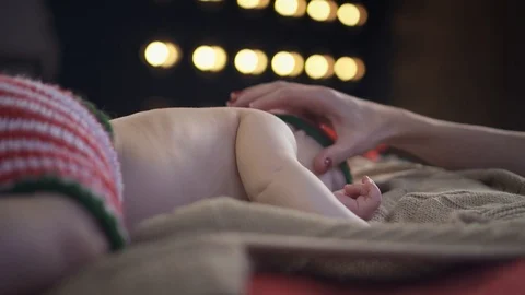 Woman gently touching her baby's cheek while he's sleeping on bed Stock Footage 86525464
