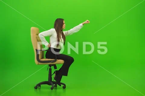 The woman gesture on the chair on the green background Stock Photos