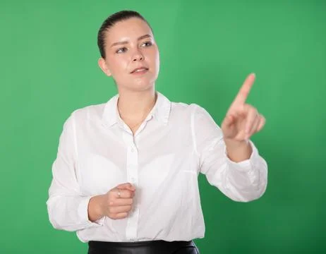 Woman gesturing with her hands while controlling virtual screen with artificial 스톡 사진