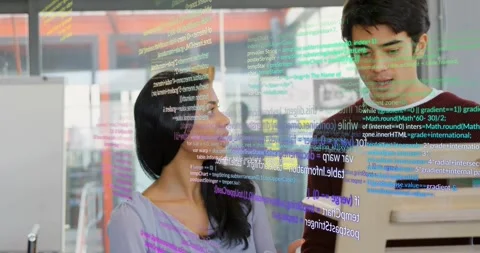 Woman gesturing at screen initiating code overlay for code review while male Stock Footage 329711149