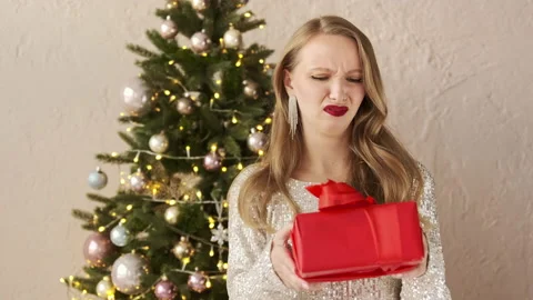 Woman gets a bad gift and throws it away. Christmas Stock Footage 166322637