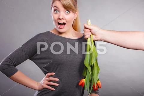 Woman gets bouquet of tulips from man. Stock Photos