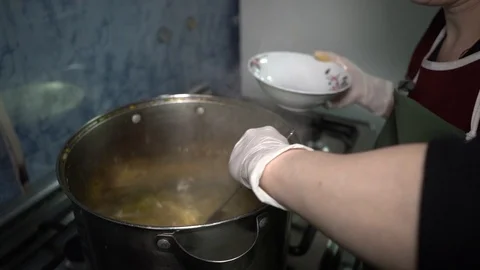 A woman gets hot soup on a jam Stock Footage