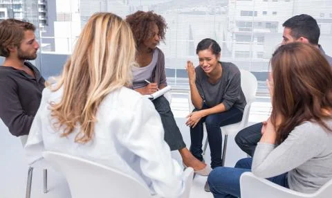 Woman getting depressed in group therapy Stock Photos