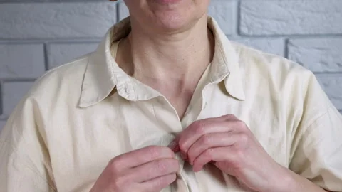 Woman getting dressed buttoning her shirt. Stock Footage 332779347