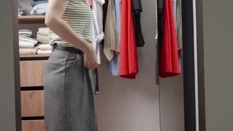 Woman getting dressed for work in wardrobe Stock Footage 337403096