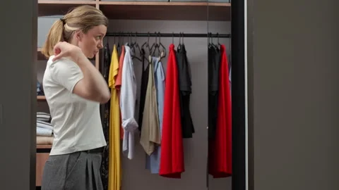 Woman getting dressed for work in wardrobe Stock Footage 337832924