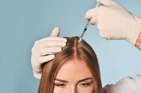 Woman is getting injection in head. Mesotherapy. Stock Photos