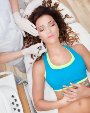 Woman getting laser face treatment in medical spa center Stock Photos