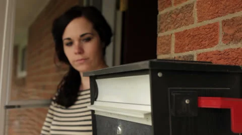 Woman getting mail from mailbox on porch jib Stock Footage