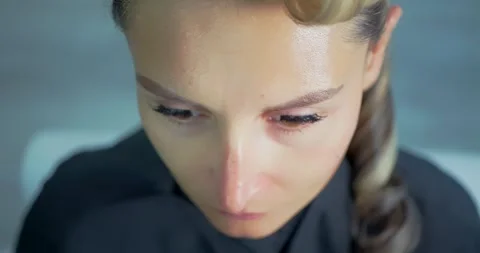 Woman Getting Makeup Done in Studio Setting Stock Footage 323493684