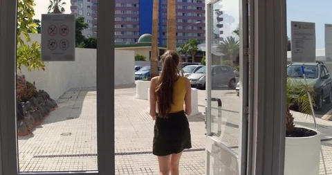 Woman Getting out of a Building Stock Footage
