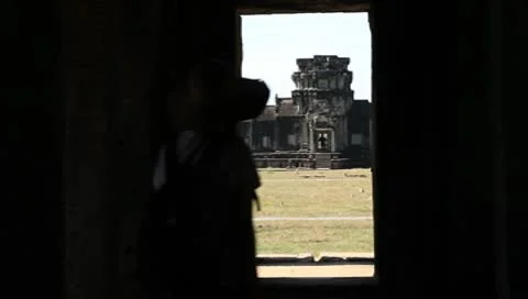 Woman getting out from temple against Angkor Wat Stock Footage