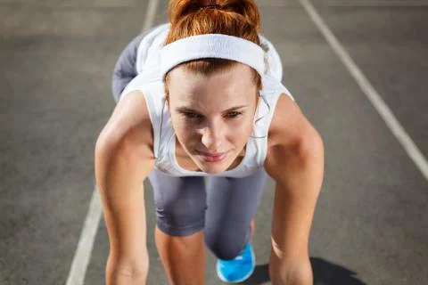 Woman getting ready to start on stadium. Stock Photos