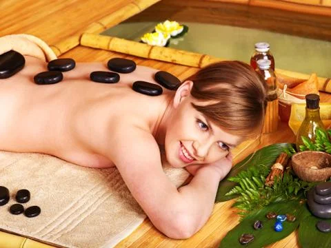 Woman getting stone therapy massage . Stock Photos