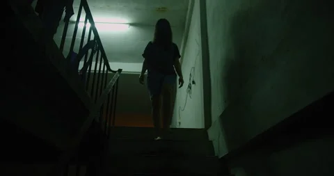 A woman ghost is walking down a dark stairwell. The image has a moody scary horr Vídeos de archivo 267071537