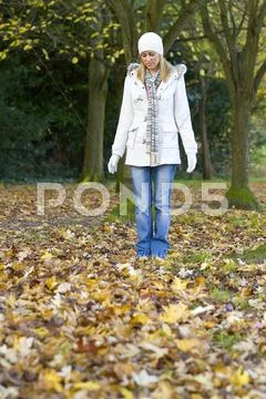 Woman girl outside in autumn leaves Stock Photos
