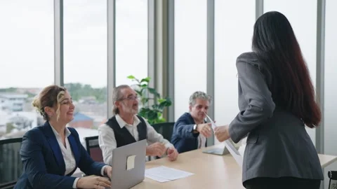 Woman giving resume and shaking hand with group of recruitment for job interview Stock Footage 249242510