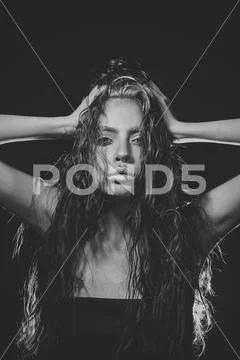 Woman with glamour makeup and long curly hair. Woman with makeup and hairstyle Stock Photos