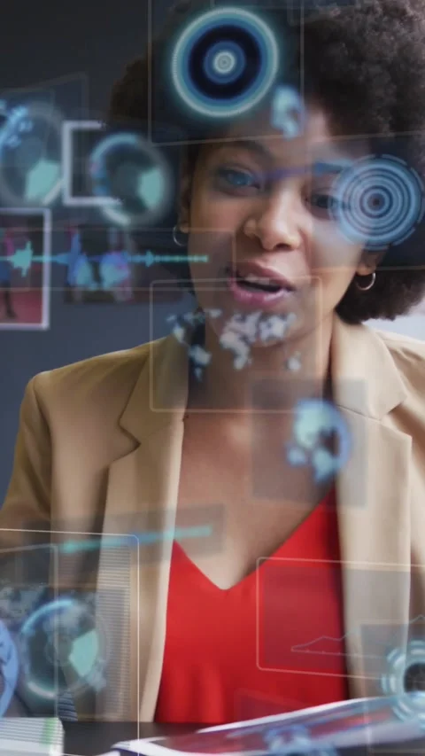 Woman glancing down at documents, activating blue holograms while reviewing Stock Footage 330242328