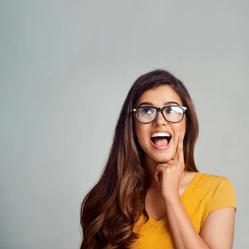 Woman, glasses and thinking in studio for decision, problem solving and Foto stock