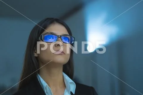 The woman with glasses on the background of projector Stock Photos
