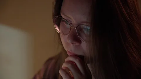 Woman in Glasses Looking at Computer Screen in Warm Light Stock Footage 344947009