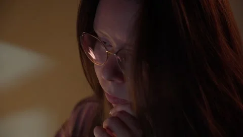 Woman in Glasses Looking at Computer Screen in Warm Light Stock Footage 344947048