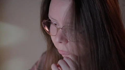 Woman in Glasses Looking at Computer Screen in Warm Light Stock Footage 344947140