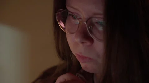 Woman in Glasses Looking at Computer Screen in Warm Light Stock Footage 344947194