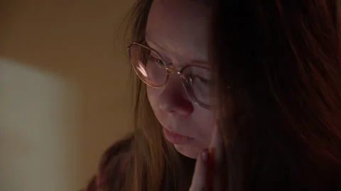 Woman in Glasses Looking at Computer Screen in Warm Light Stock Footage 344947273