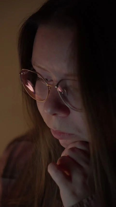 Woman in Glasses Looking at Computer Screen in Warm Light Stock Footage 344949896