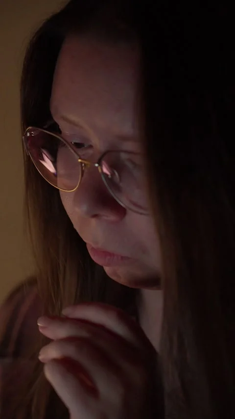 Woman in Glasses Looking at Computer Screen in Warm Light Stock Footage 344949944
