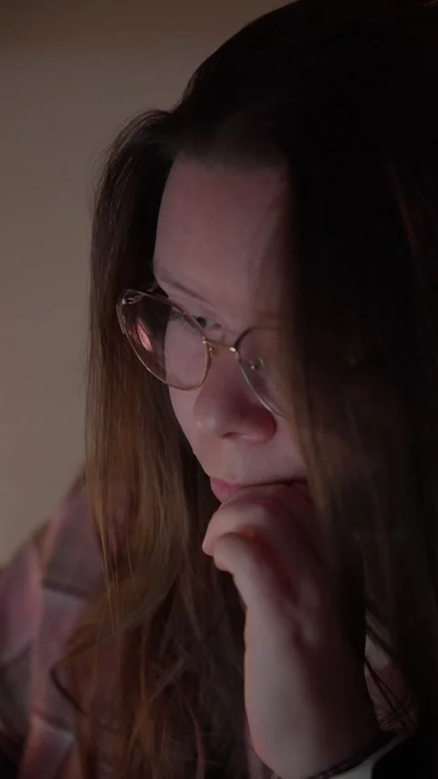 Woman in Glasses Looking at Computer Screen in Warm Light Stock Footage 344950123