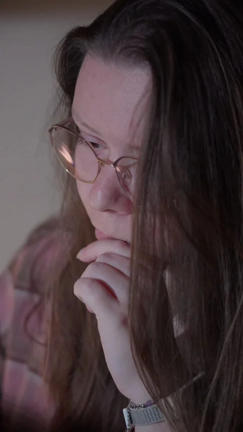 Woman in Glasses Looking at Computer Screen in Warm Light Stock Footage 344950203