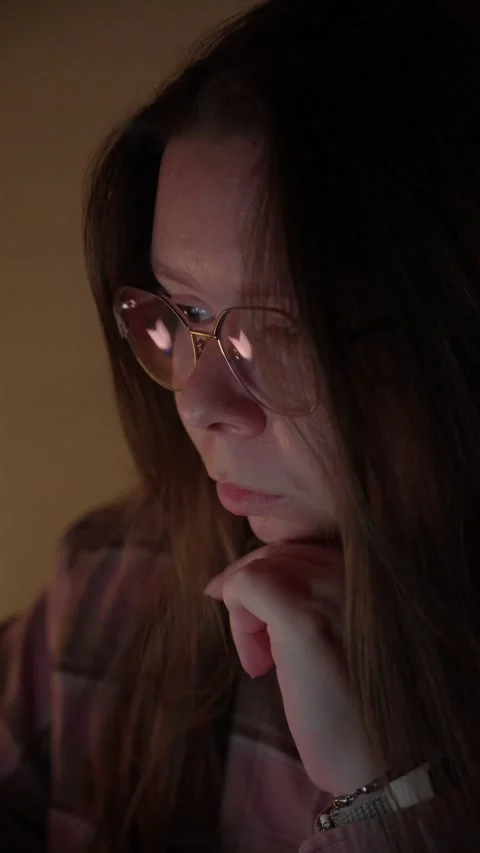 Woman in Glasses Looking at Computer Screen in Warm Light Stock Footage 344950234